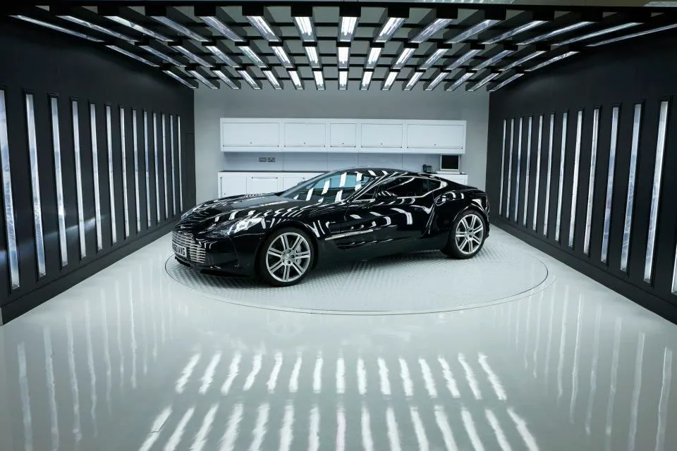 Black sports coupe surrounded by vertical studio lights